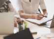 Business partners reviewing cosmetology school reports