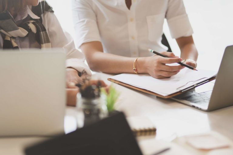 Business partner exchanging their idea about the new project Business partners reviewing cosmetology school reports