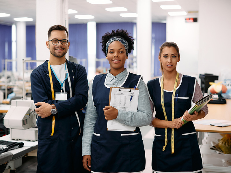 multiracial-group-of-happy-tailors-at-clothing